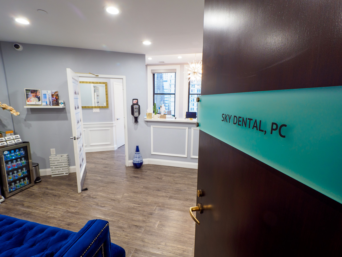 Entrance to Sky Dental, offering a modern dental experience in NYC! Office door is open to waiting room, a welcoming view.